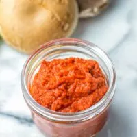 A simple homemade red curry paste in a glass bowl.