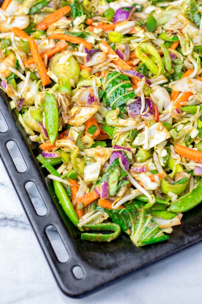 Fresh Thai vegetables on a single sheet pan, ready to go into the oven.