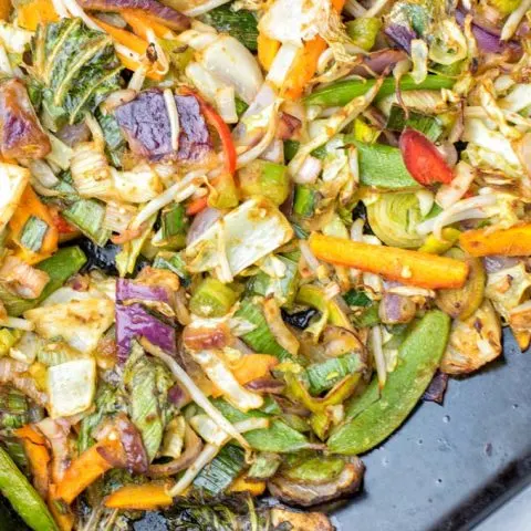 Cabbage, sugar snaps, and carrots are among the veggies on this sheet pan.