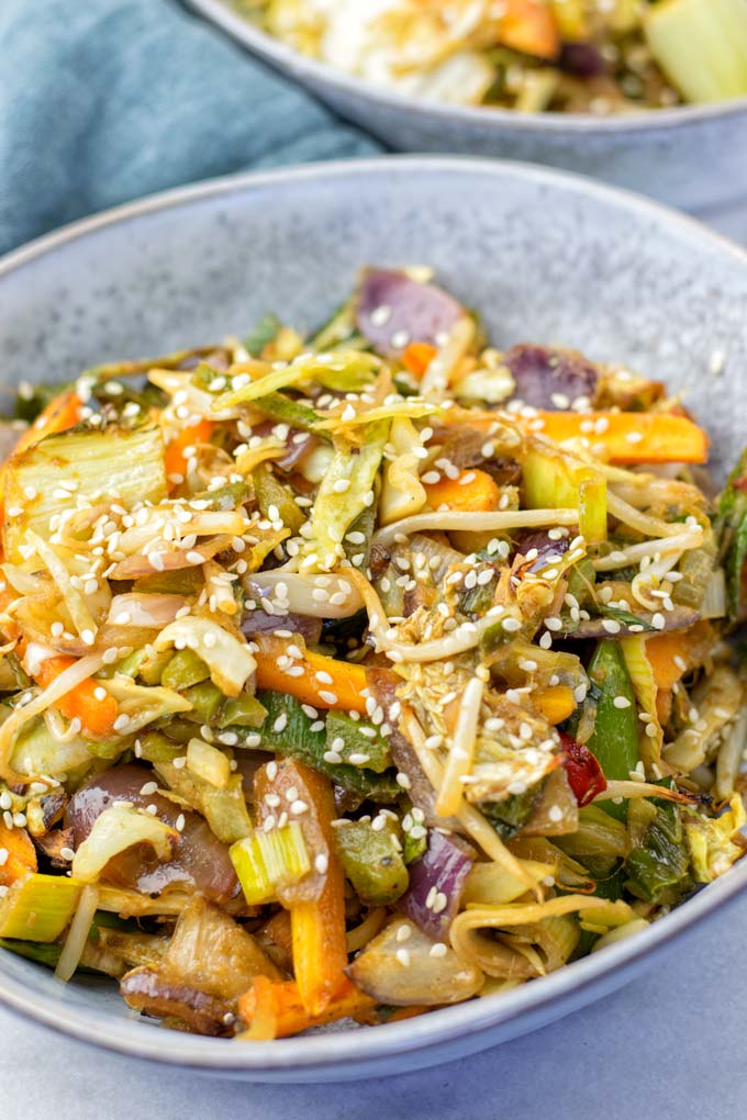 A bowl with the Sheet Pan Thai Vegetables, garnished with sesame seeds.