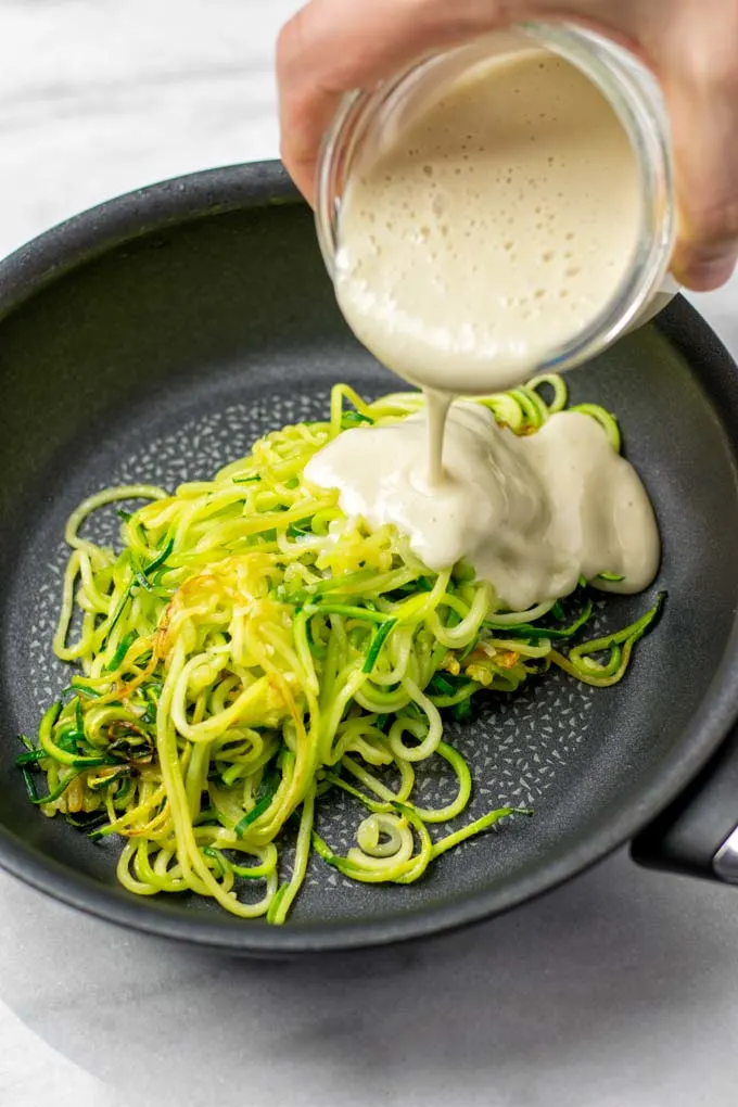 The sauce is poured over the zoodles.