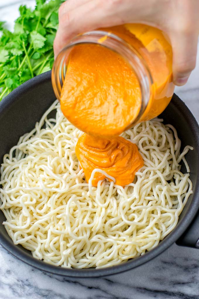 Sauce is poured over wok noodles.