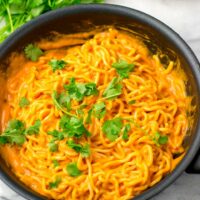 Yum Yum Noodles decorated with cilantro in a sauce pan.