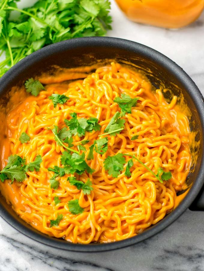 Yum Yum Noodles decorated with cilantro in a sauce pan.
