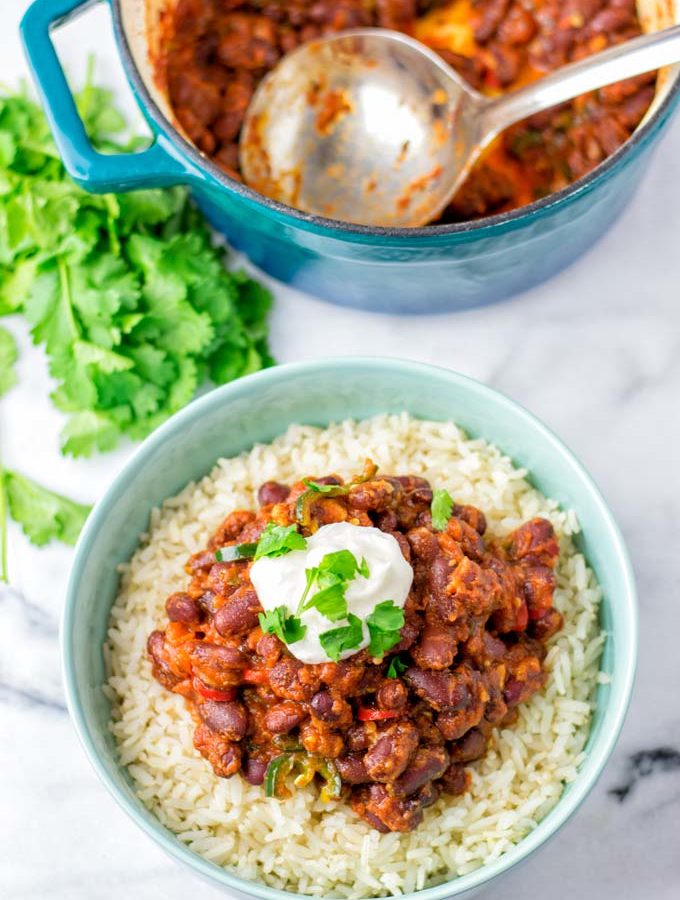 A spoonful of sour cream is given on top the beans.