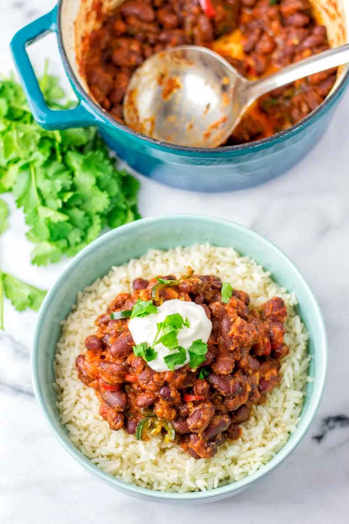 A spoonful of sour cream is given on top the beans.