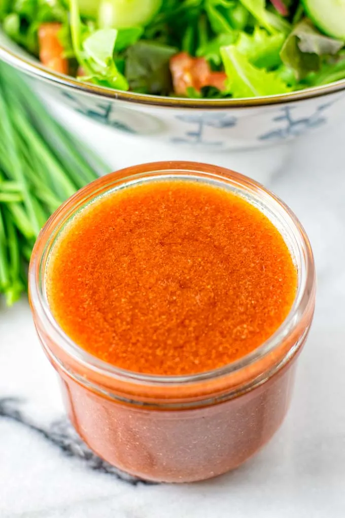 Closeup view of a glass jar with the dressing.