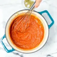 Whisking everything together for this easy vegan EncAdd seasoning to the Enchilada Sauce.Add seasoning to the Enchilada Sauce.Add seasoning to the Enchilada Sauce.hilada Sauce.