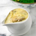 Closeup view of the gravy in a sauce dish.