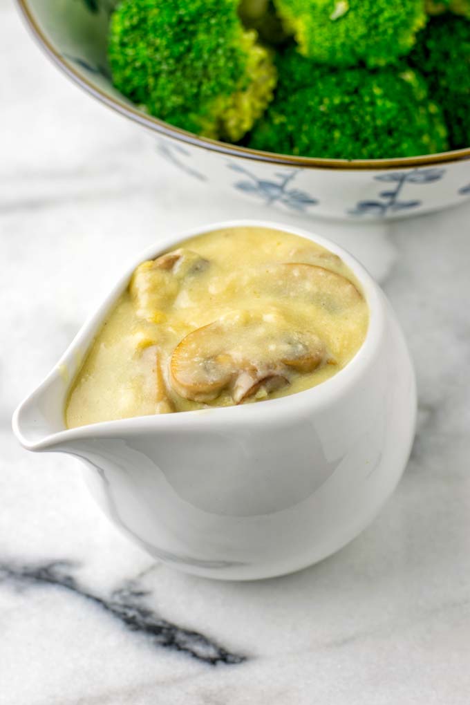 Closeup view of the gravy in a sauce dish.