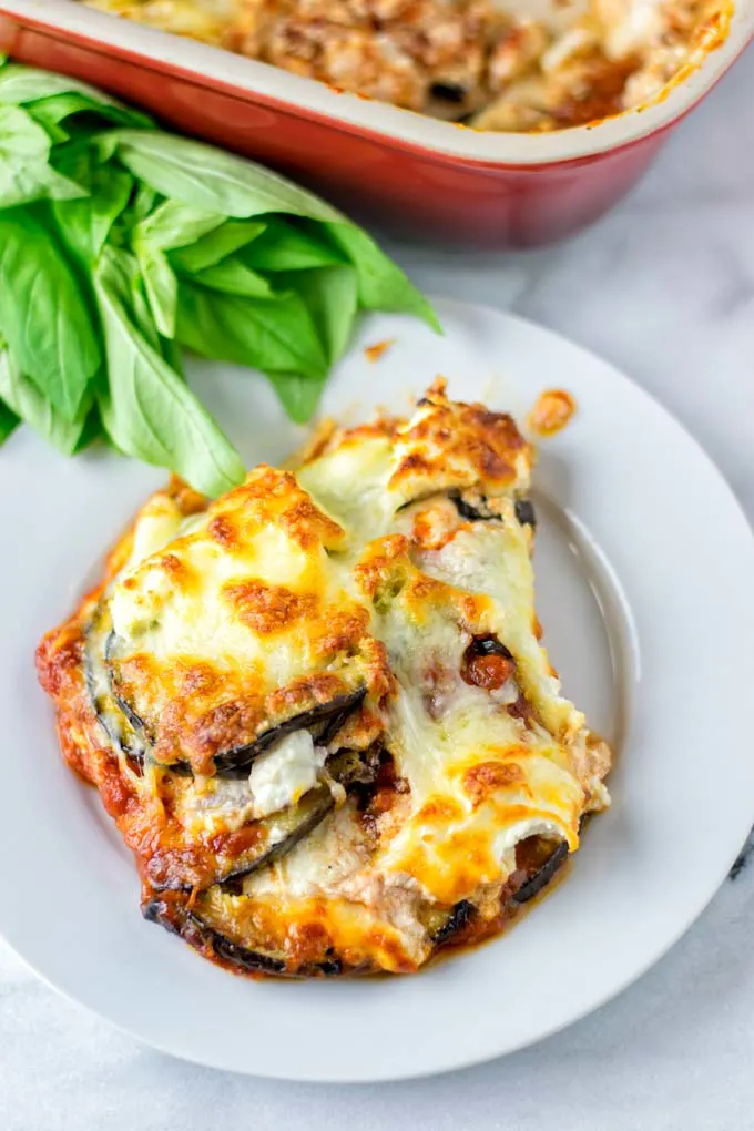 Portion of the ready lasagna on a white plate.