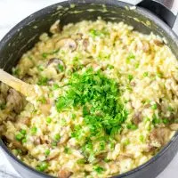 Large saucepan with the Mushroom Risotto, garnished with fresh parsley.