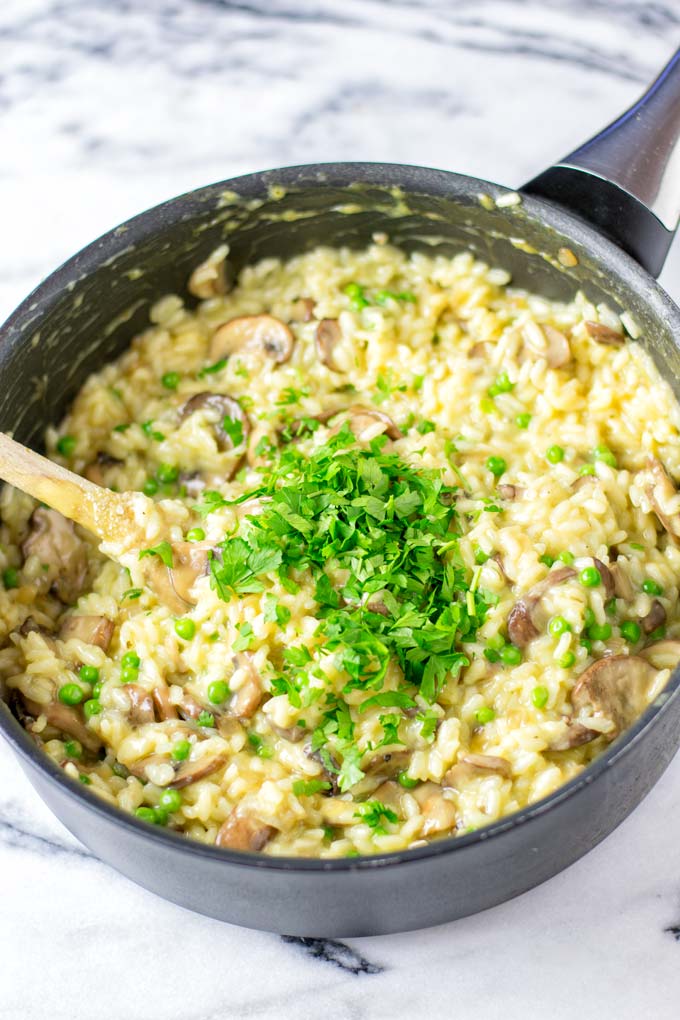 Large saucepan with the Mushroom Risotto, garnished with fresh parsley.
