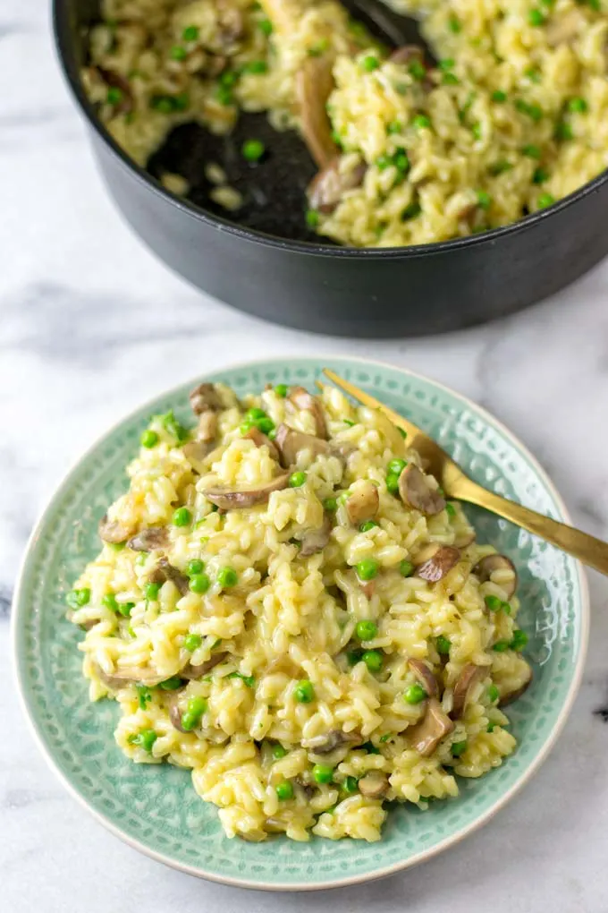 Enjoying a portion of the mushroom risotto with thee cooking pan in the background.