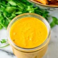 Awesome Sauce in a small glass jar with sweet potato fries in the background.