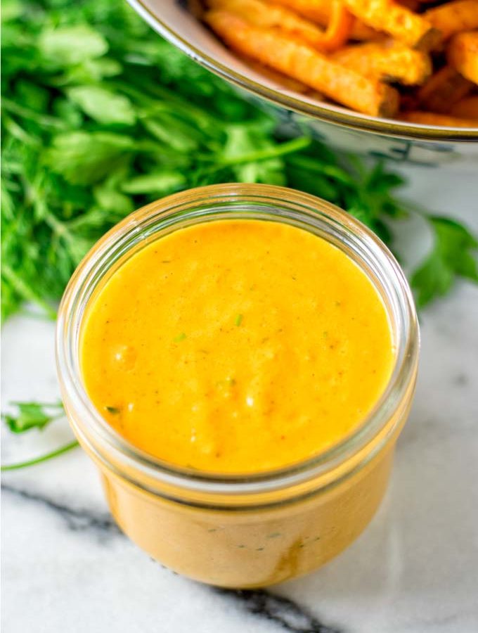 Awesome Sauce in a small glass jar with sweet potato fries in the background.