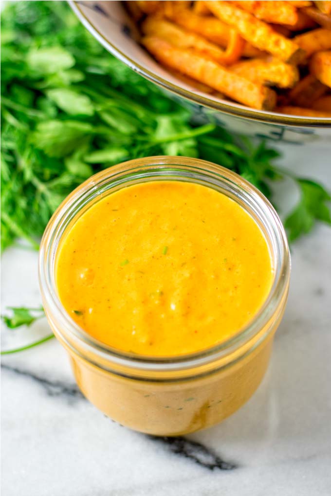 Awesome Sauce in a small glass jar with sweet potato fries in the background.