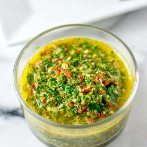 The ready Chimichurri Sauce in a glass jar.