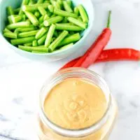 Ready sauce with fresh vegetables in the background.