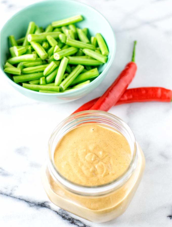 Ready sauce with fresh vegetables in the background.