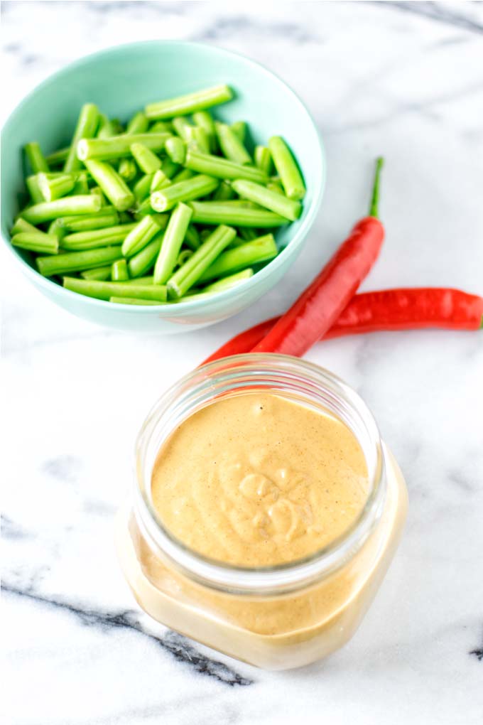 Ready sauce with fresh vegetables in the background.