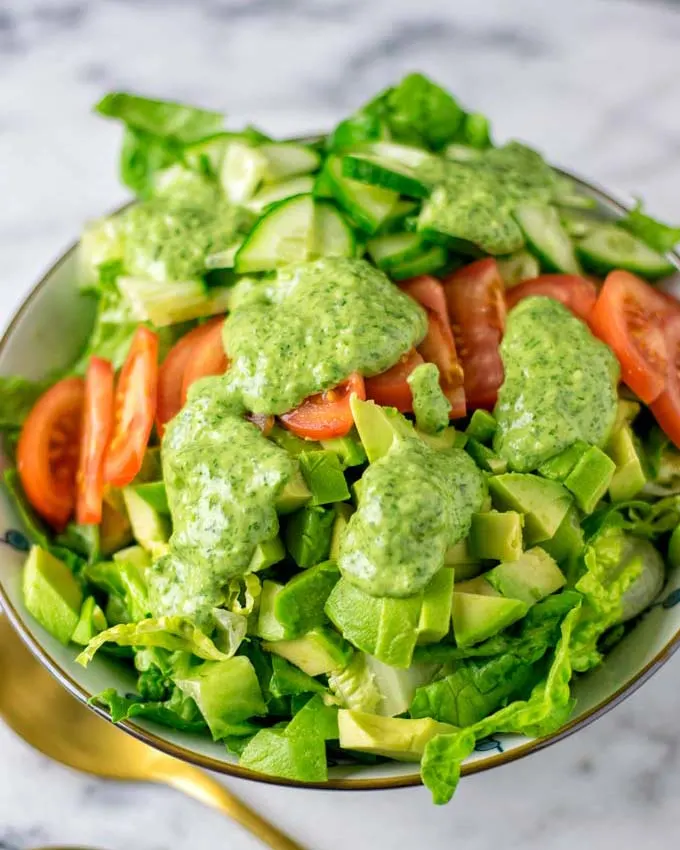 The dressing used over a fresh, mixed salad.