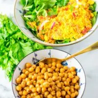 Bowl of Roasted Chickpeas with a fresh mixed lunch salad in the background.