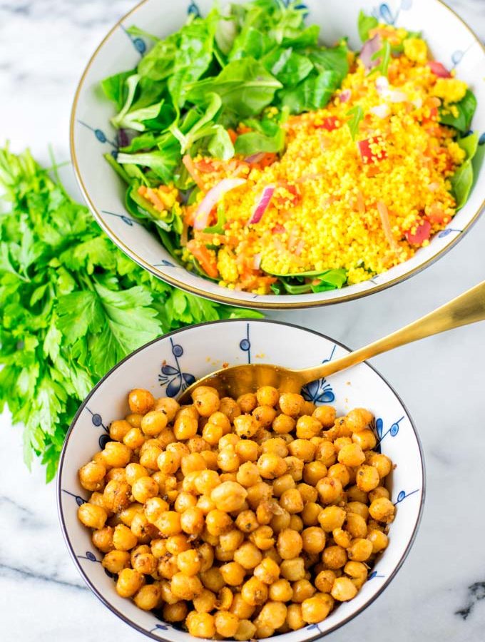 Bowl of Roasted Chickpeas with a fresh mixed lunch salad in the background.