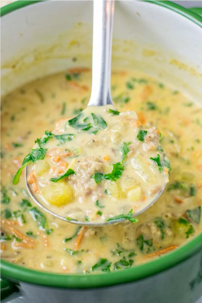 Closeup view of the Zuppa Toscana in a large soup spoon.