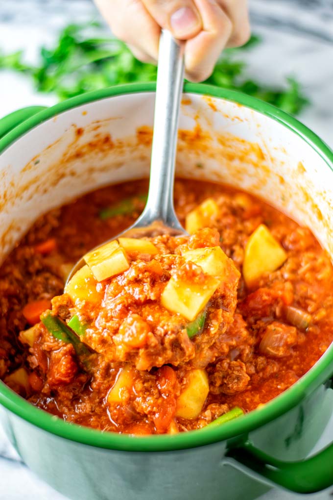 A big spoonful of the Hamburger Soup is taken out of the pot.