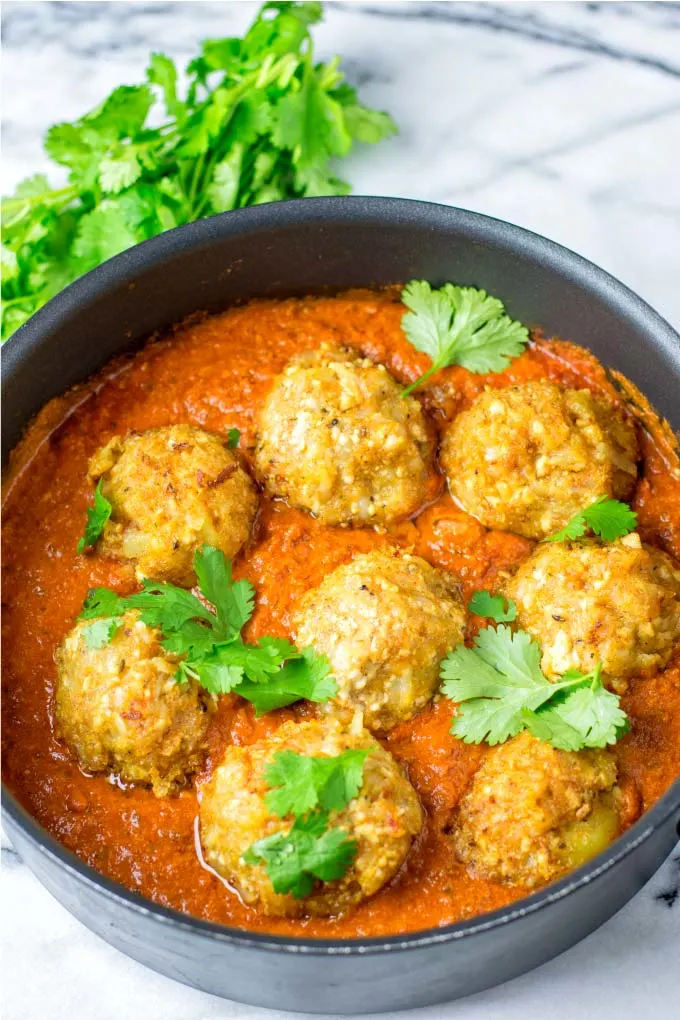 Malai Kofta in a large pan, garnished with cilantro.