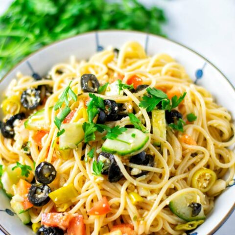 Closeup view of the Spaghetti Salad garnished with fresh parsley.