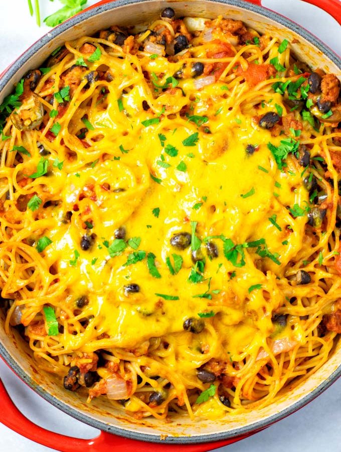 Top view on the red casserole with the ready Taco Spaghetti.