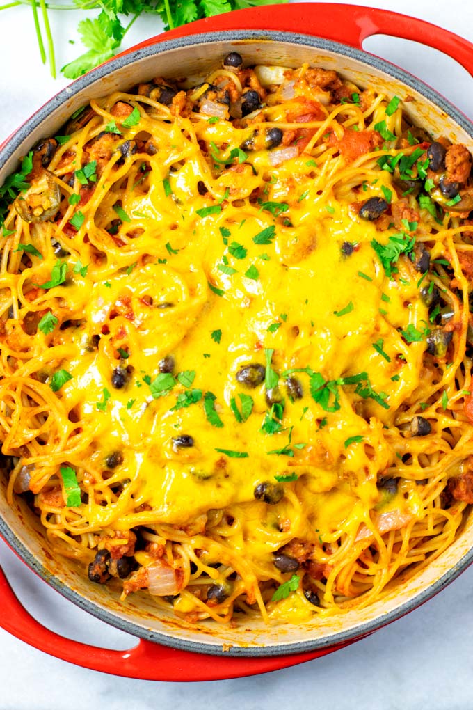 Top view on the red casserole with the ready Taco Spaghetti.