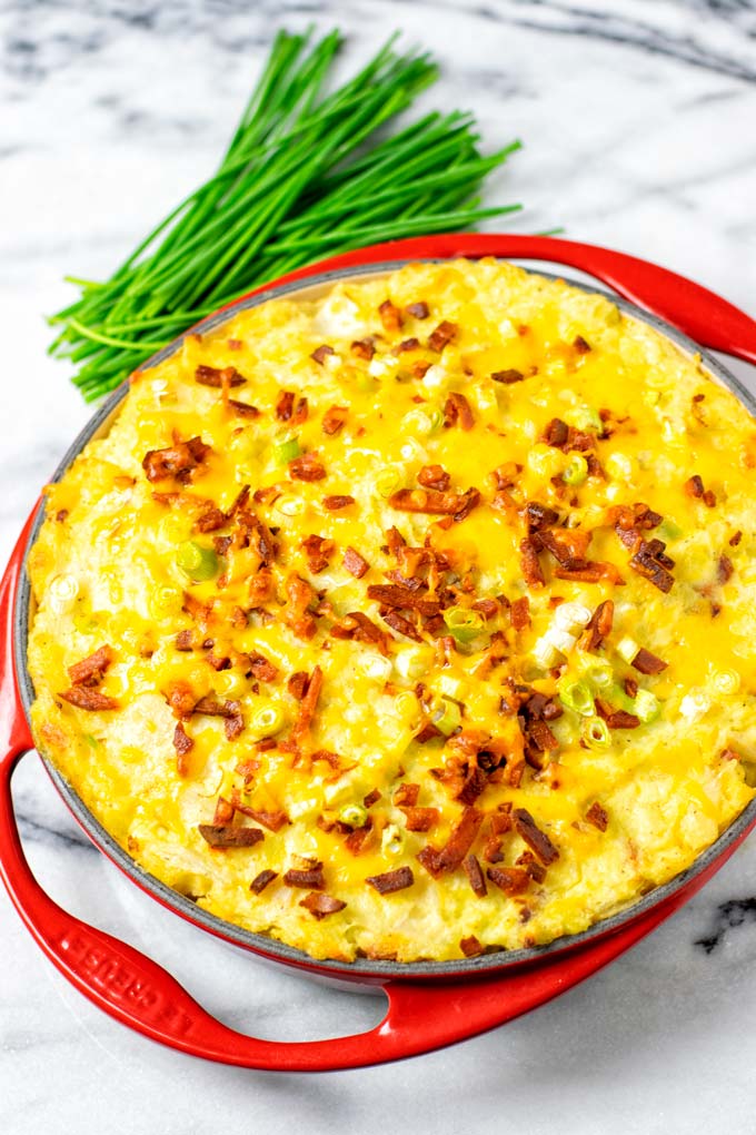 Red baking dish with the cross twice baked potato casserole.