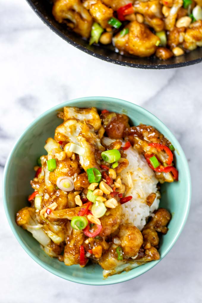 Portion of the Kung Pao Cauliflower served on rice in a small bowl.