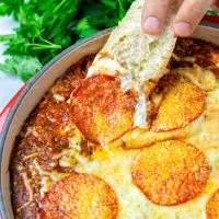 Dipping some bread into the vegan Pizza Dip.