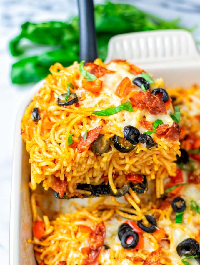 A large portion of the Pizza Spaghetti is lifted from the casserole.