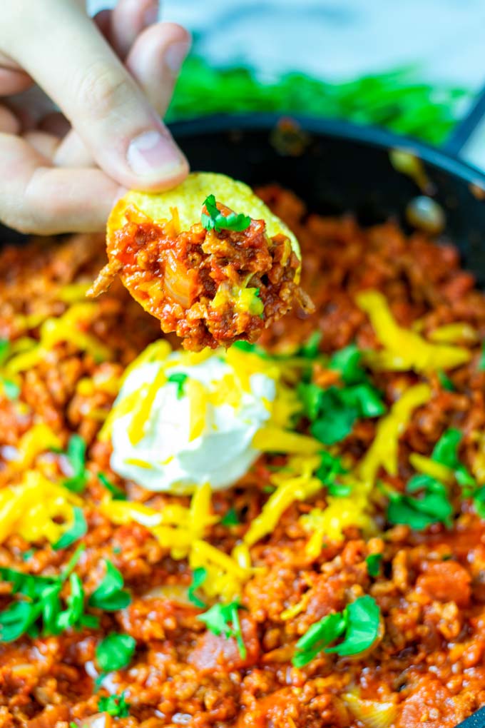 Dipping a nacho chip into the Texas Chili.