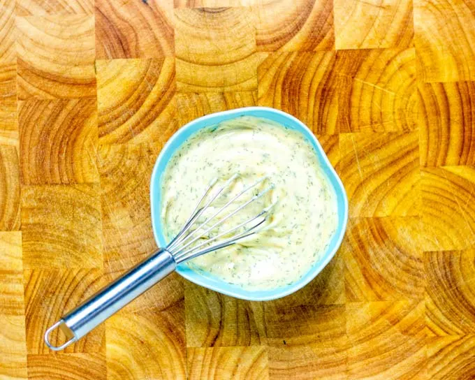 Small bowl with the Burger Sauce with a small wire whisk.