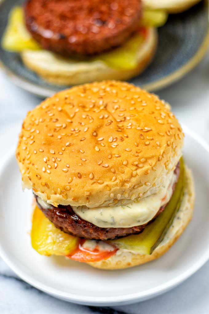 A closed burger, showing the creamy Burger Sauce running from the top.