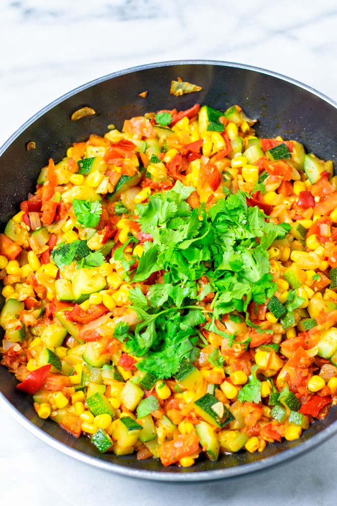 Fresh cilantro garnish over a pan of Calabacitas.