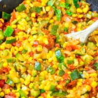 Wooden spoon in a pan with Calabacitas.