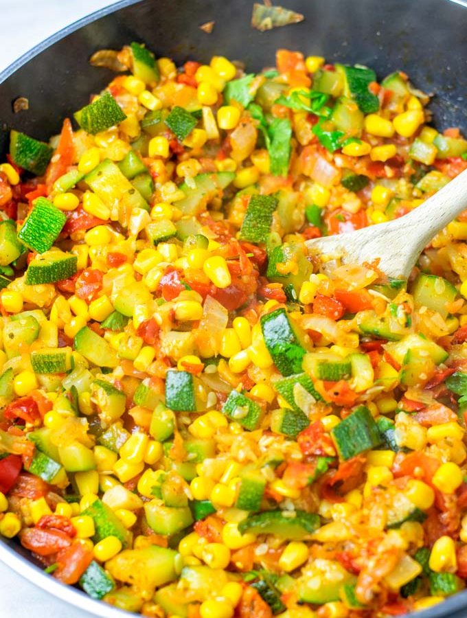 Wooden spoon in a pan with Calabacitas.