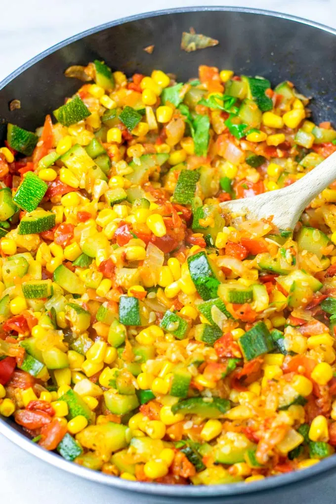 Wooden spoon in a pan with Calabacitas.