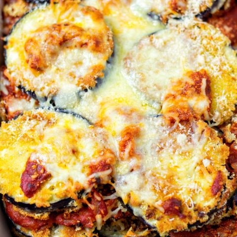 Closeup view on the Eggplant Parmesan showing the baked layers of eggplant, tomato sauce, and cheeses.