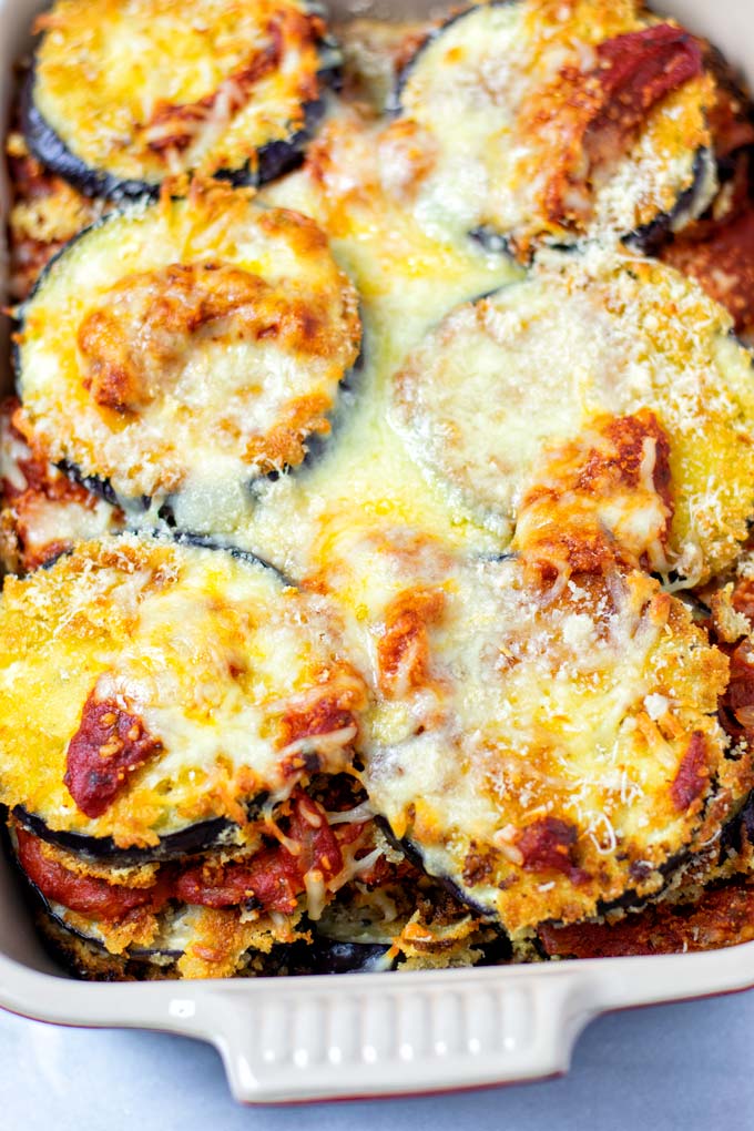 Closeup view on the Eggplant Parmesan showing the baked layers of eggplant, tomato sauce, and cheeses.