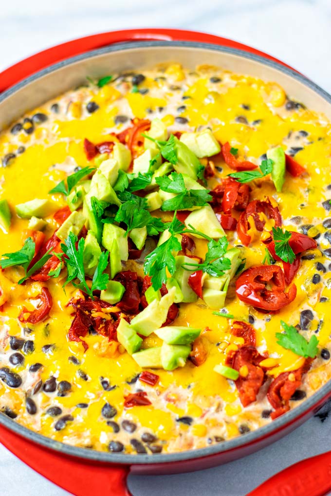 Closeup on the Nacho Dip, decorated with extra avocado and cilantro.