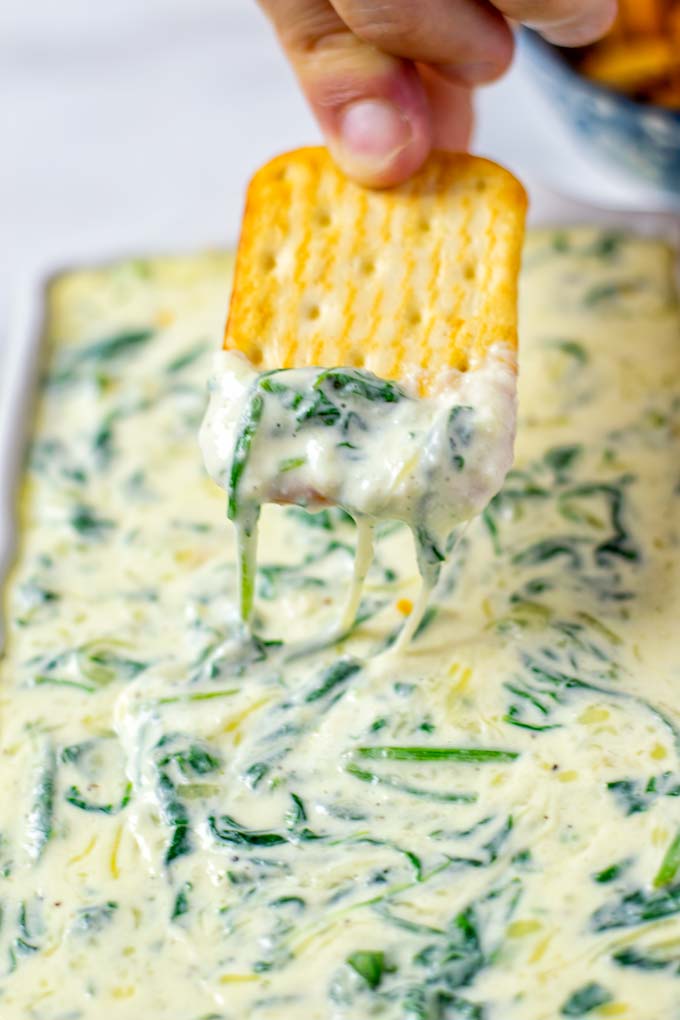 Dipping a cracker into the Spinach Dip.