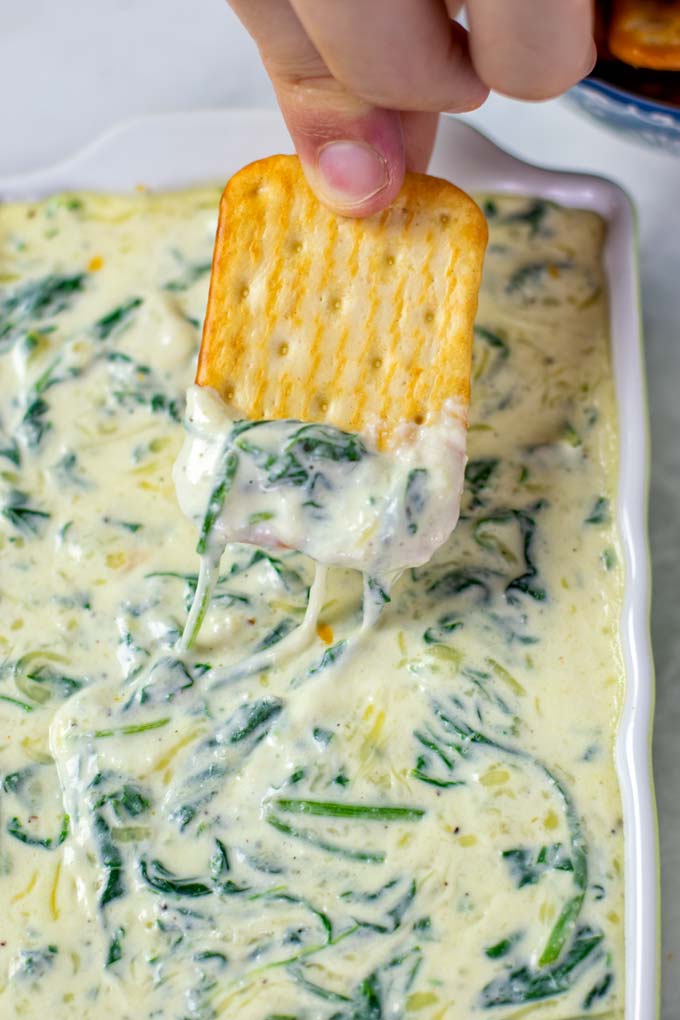 Closeup of a cracker with Spinach Dip.